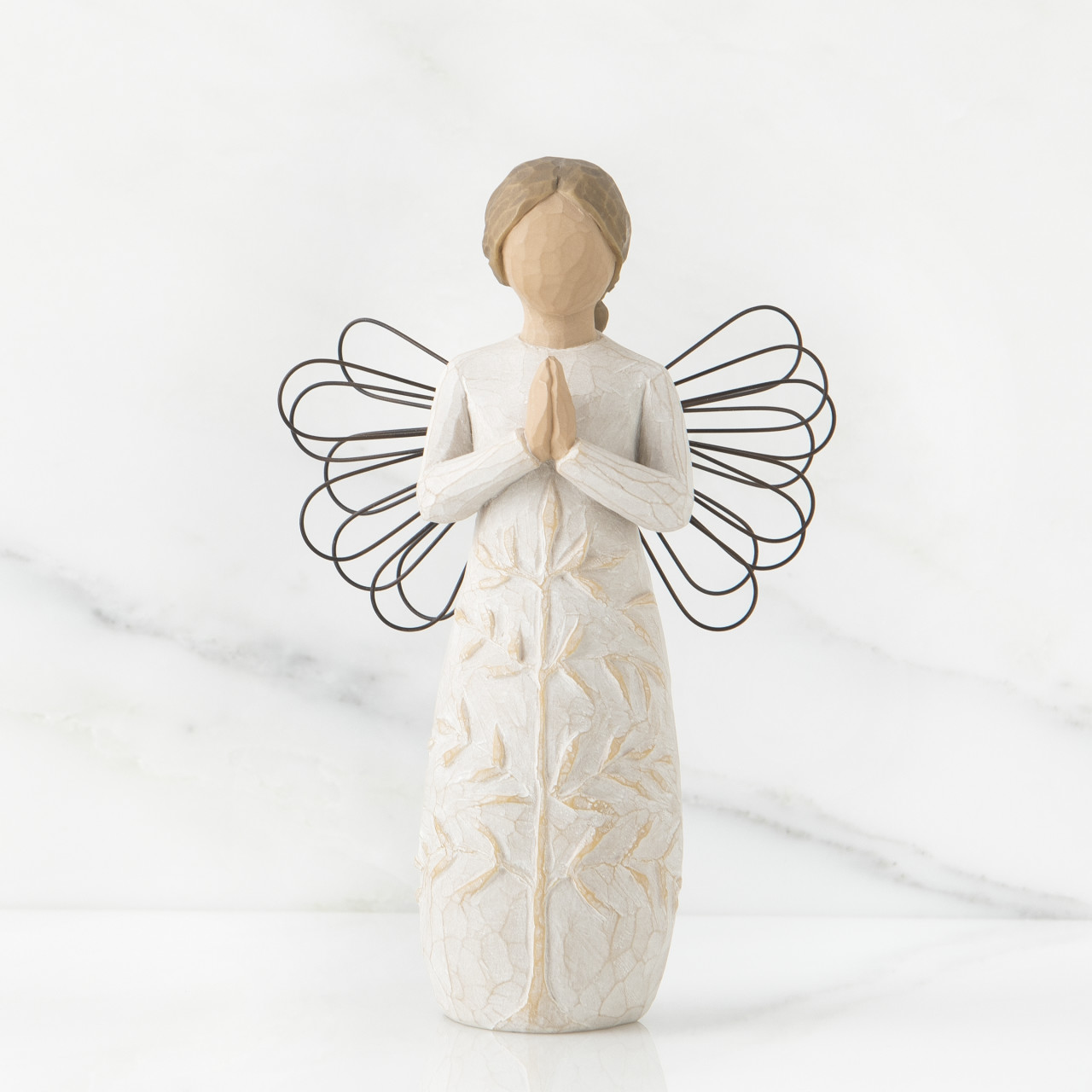 a tree, a prayer sculpted angel by Susan Lordi