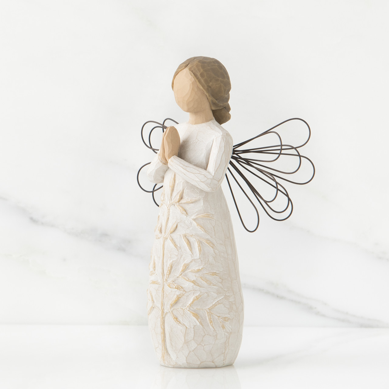 a tree, a prayer sculpted angel by Susan Lordi